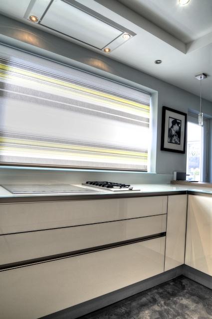 10,5mm toughened glass work surfaces with induction and gas hobs with Westin ceiling extractor.