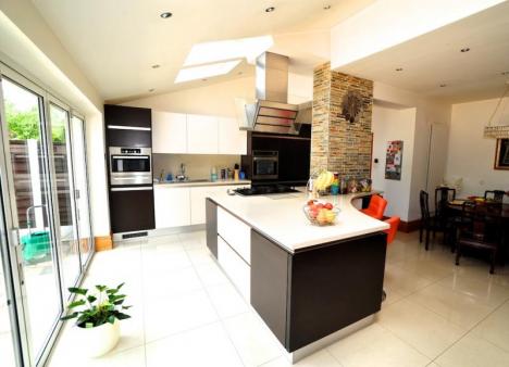 handleless fitted kitchen with Corian tops and Kuppersbusch appliances-