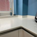 the composite worktop is joined seamlessly at corners, upstands, and windowsill providing a hygienic and clean looking finish