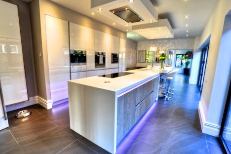 new fitted kitchen with Corian worktops and high-gloss kitchen island with Quooker hot tap