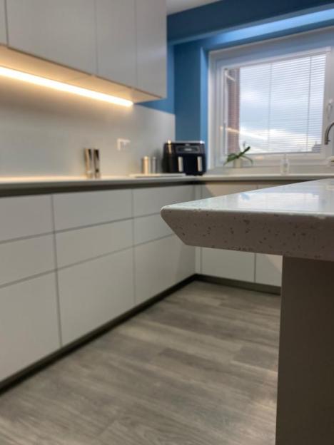the shark's nose detailing around the worktop is elegant and tactile and provides a softened corner to the breakfast bar end