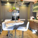 Clam shell corian breakfast bar replaces dark Iroko design kitchen laminate top