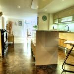 Looking through the cosy kitchen tot he sunny dining room. Flooring by Amtico.