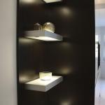 illuminated floating shelves soften the look of the kitchen