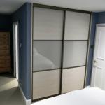 Sliding wardrobe doors with glass and melamine panels
