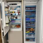left hand fridge and right hand tall freezer open to give an example of how much storage can be created with integrated appliances