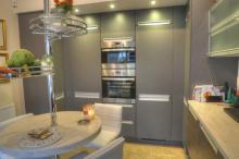 Clam Shell corian replaces a dark Iroko design kitchen