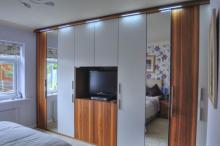 Fitted bedroom finished in walnut veneer & silk lacquer.